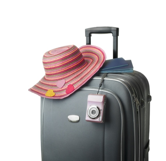 Luggage with camera, passports and woman's hat